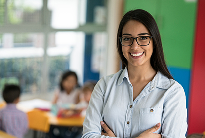 Smiling educator standing in a children's services environment