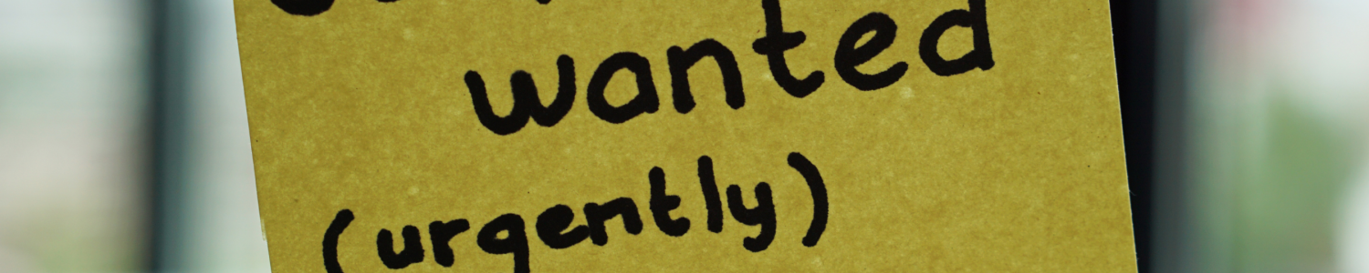Photo of a post it note that reads "staff wanted (urgently)"