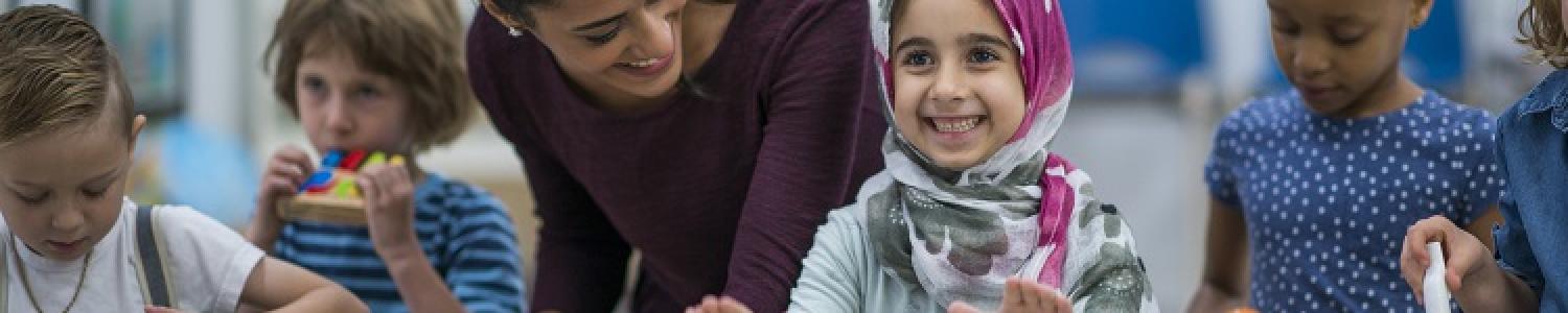 Child in head scarf playing bongo drums