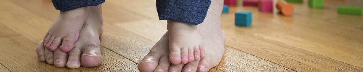 Child standing on adults feet