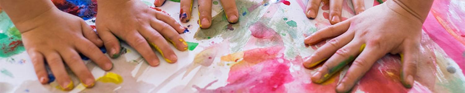 Children's making handprints on canvas