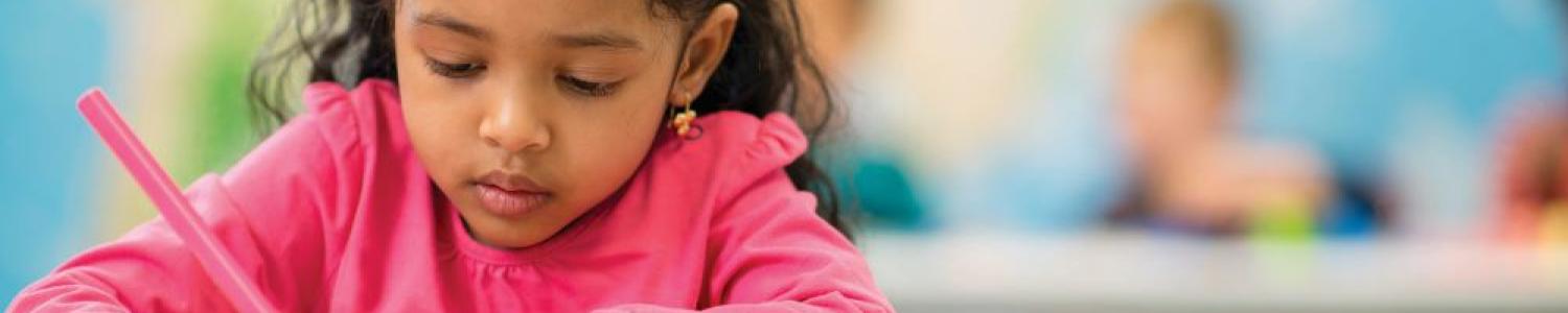 Child colouring at a table