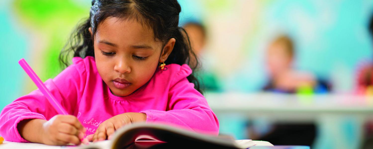 Girl colouring at desk