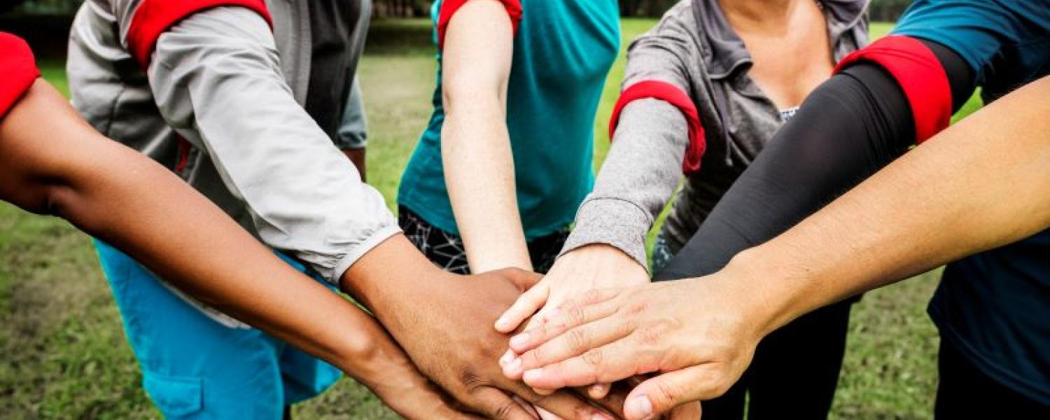 Group of educators stacking hands