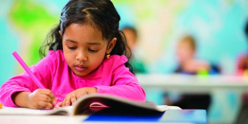 Girl colouring at desk