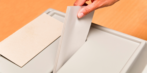 Envelope being placed in election ballot box