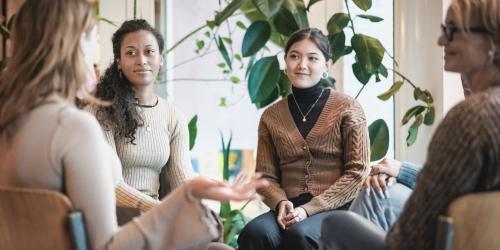 Educators sitting in a circle sharing their experiences
