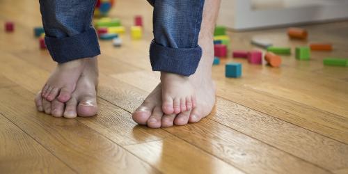 Child standing on adults feet