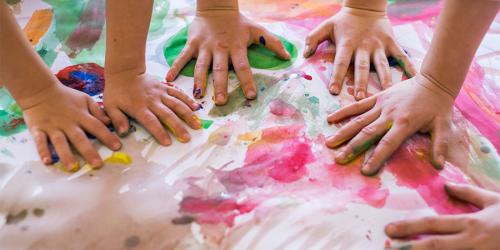 Children's making handprints on canvas