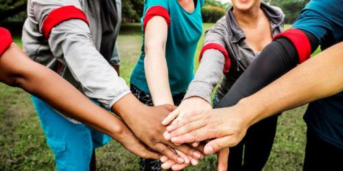 Group of educators stacking hands
