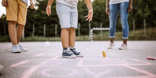 Children playing hopscotch in a school yard