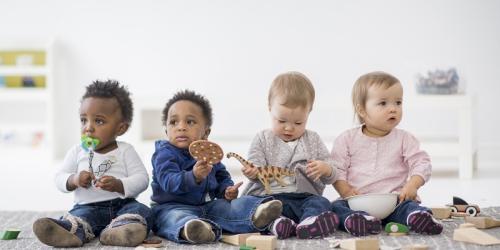 Infants sitting in a row