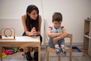 Concerned educator addressing unhappy child