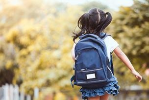 School-aged child with backpack