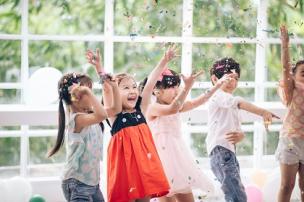 Children with hands in the air, celebrating